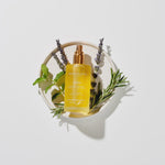 Load image into Gallery viewer, Bottle of Eden Body Oil with herbs on a white background