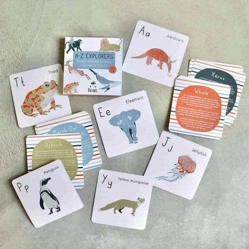 Educational cards with animals and letters on a textured surface