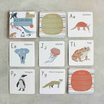 Load image into Gallery viewer, Set of educational alphabet cards with animal illustrations on a gray surface
