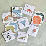 Load image into Gallery viewer, Educational cards with animals and letters on a textured surface
