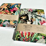 Load image into Gallery viewer, Two notebooks with colorful animal and nature-themed designs on a white surface, featuring the brand &#39;Moon &amp; Back&#39;.
