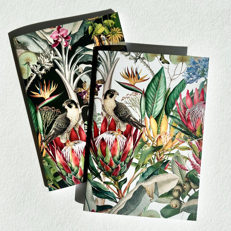 Two decorative notebooks with tropical bird and flower designs on a white background.