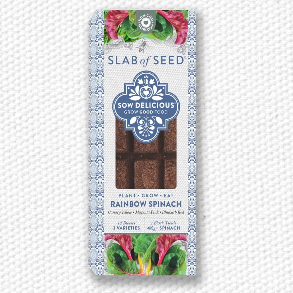 Packaged rainbow spinach seeds with 'Slab of Seed' branding on a textured white background