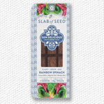 Load image into Gallery viewer, Packaged rainbow spinach seeds with &#39;Slab of Seed&#39; branding on a textured white background
