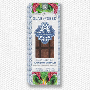 Packaged rainbow spinach seeds with 'Slab of Seed' branding on a textured white background
