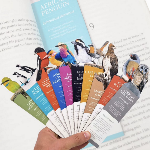 Collection of bird-themed bookmarks held over a book.