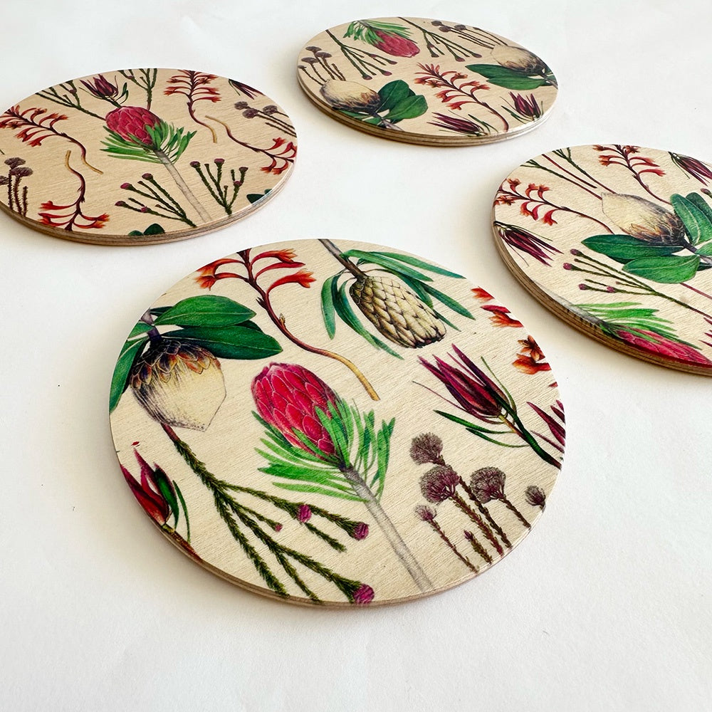 Set of round coasters with floral designs on a white background