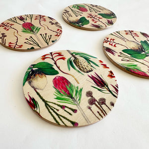Set of round coasters with floral designs on a white background