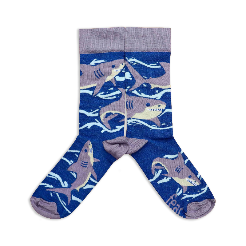A pair of socks with a blue background featuring great white shark illustrations.