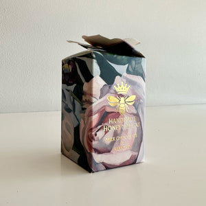 Handmade honey nougat packaging with floral design and bee logo on a white background