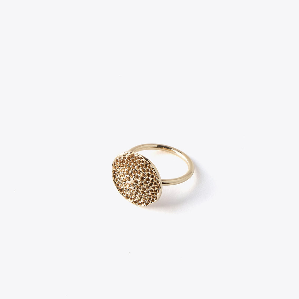 Bronze ring with textured design on a white background