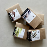 Load image into Gallery viewer, Five brown soap boxes with labels on a light gray background
