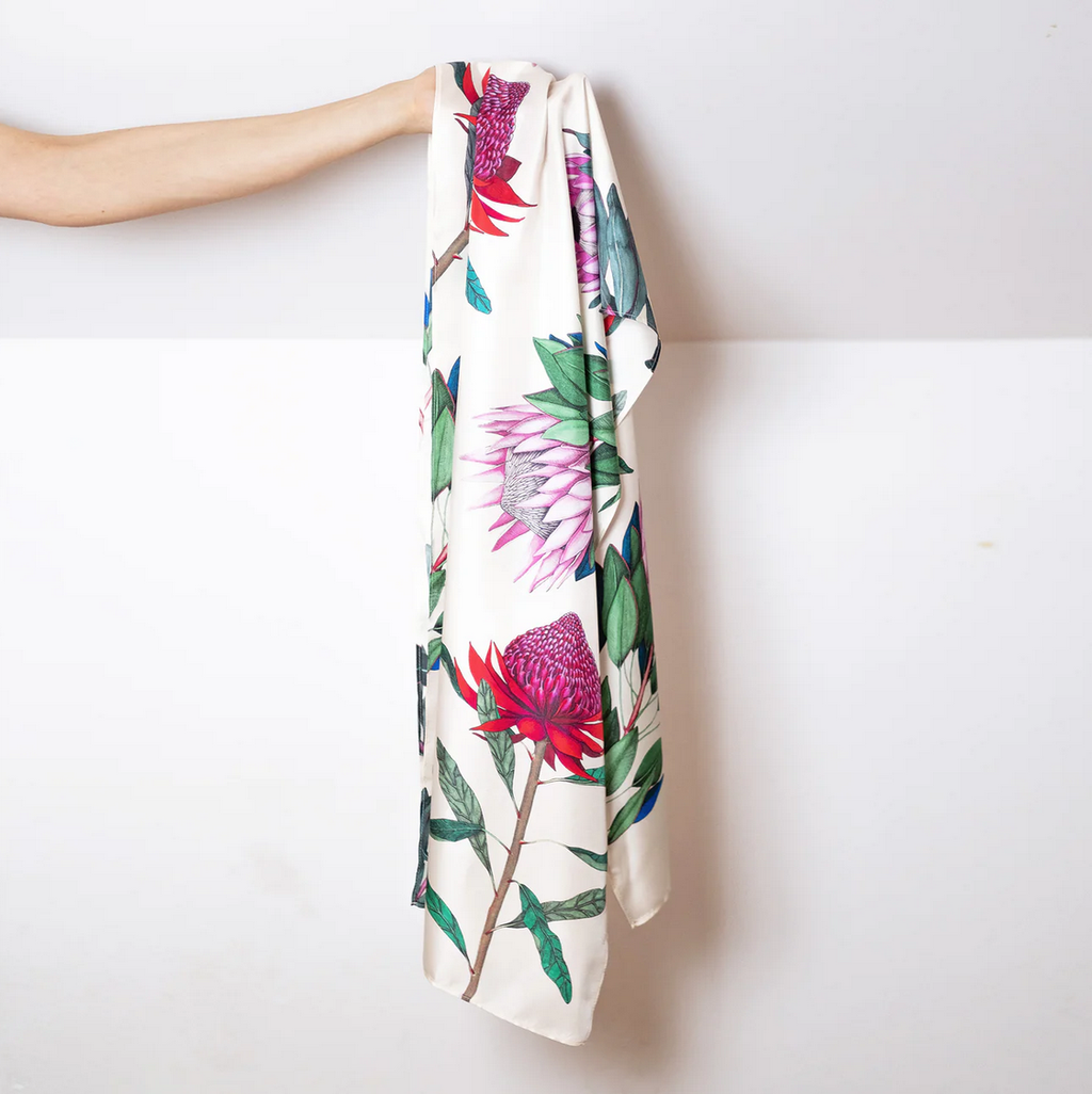 Floral patterned silk scarf with pink and green flowers on a white background