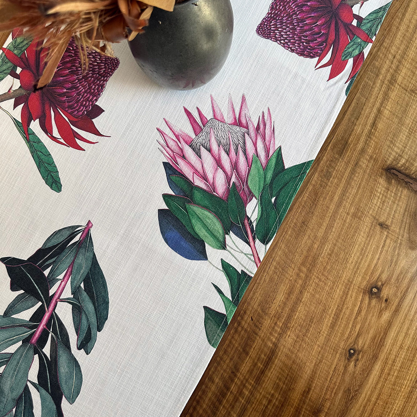 Protea floral patterned tablecloth on a wooden table