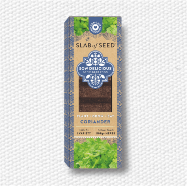 Box of coriander seeds with 'Slab of Seed' branding on a textured white background