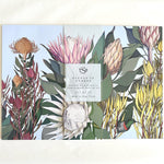 Load image into Gallery viewer, Set of paper placemats with fynbos design and brand label on a white background
