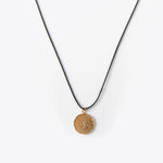 Load image into Gallery viewer, Necklace with a textured bronze pendant on a white background
