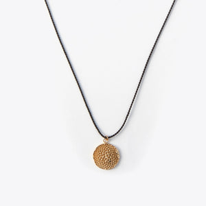 Necklace with a textured bronze pendant on a white background