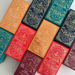 Load image into Gallery viewer, Sunbird Superior rooibos tea packages in various colors on a white background
