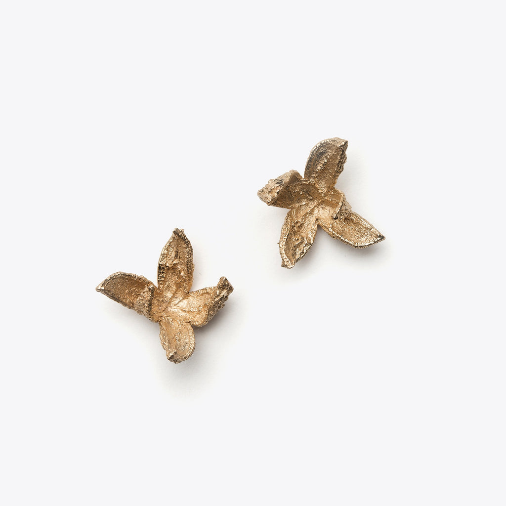 Bronze flower earrings on a white background