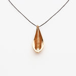 Load image into Gallery viewer, Bronze teardrop shaped pendant on a black cord against a white background
