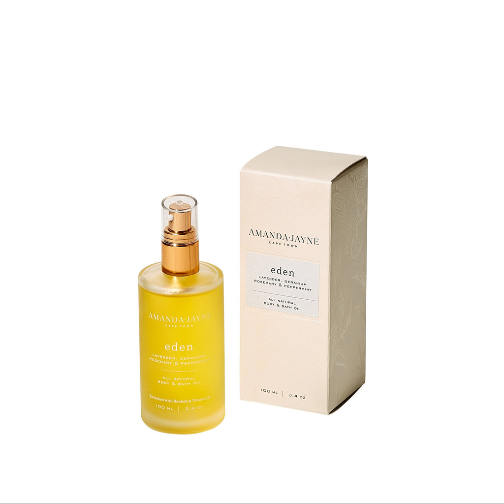 Yellow bottle with gold cap and beige box labeled 'Amanda Jayne' on a white background