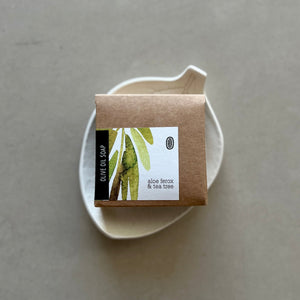 Olive oil soap packaging with a natural design on a gray background