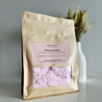 Load image into Gallery viewer, Kraft paper packaging of bath salts with a pink label on a neutral background
