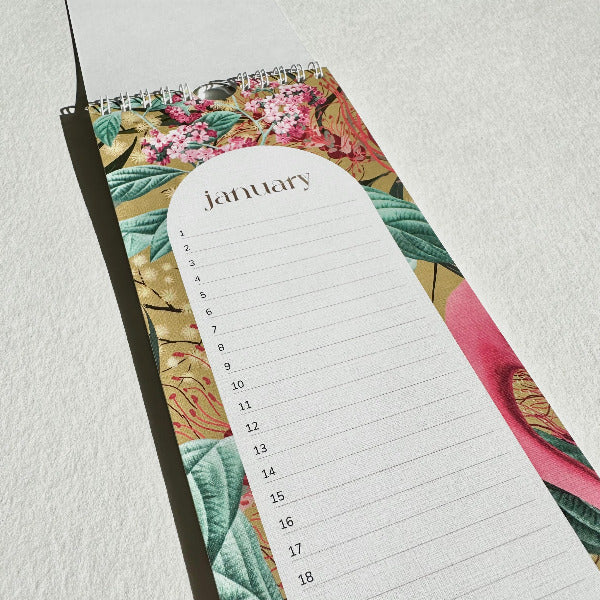 Floral-patterned planner with a January calendar on a light gray background