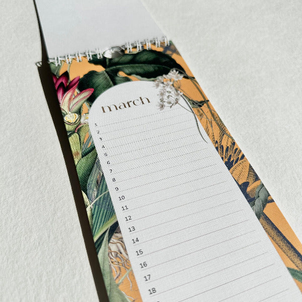 Floral-patterned notepad with a March calendar on a light gray background