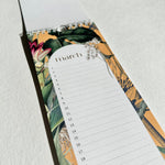 Load image into Gallery viewer, Floral-patterned notepad with a March calendar on a light gray background
