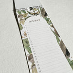 Load image into Gallery viewer, Floral-patterned planner with a calendar for October on a light gray background
