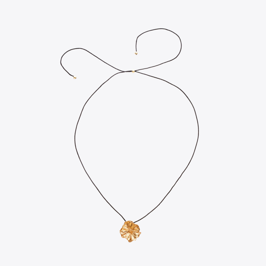 Bronze necklace with a floral pendant on a white background