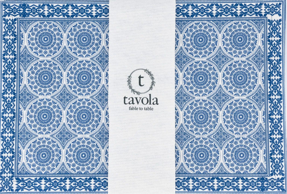 Blue and white patterned placemat with 'tavola' branding on a white background.