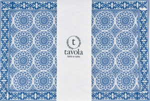 Blue and white patterned placemat with 'tavola' branding on a white background.