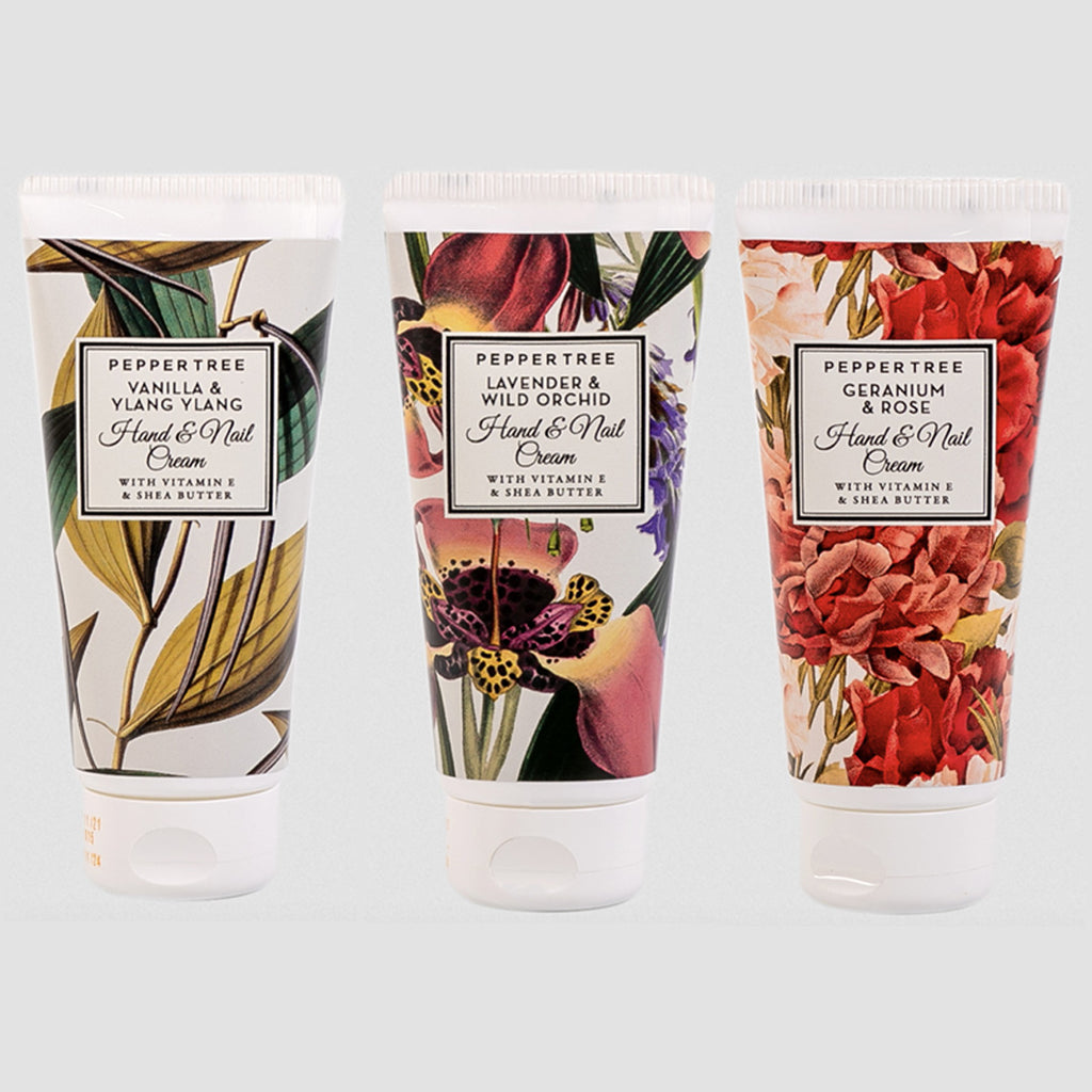 Three tubes of hand cream with floral designs on labels against a light gray background