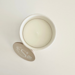 Load image into Gallery viewer, Round white candle in a white container on a light gray background
