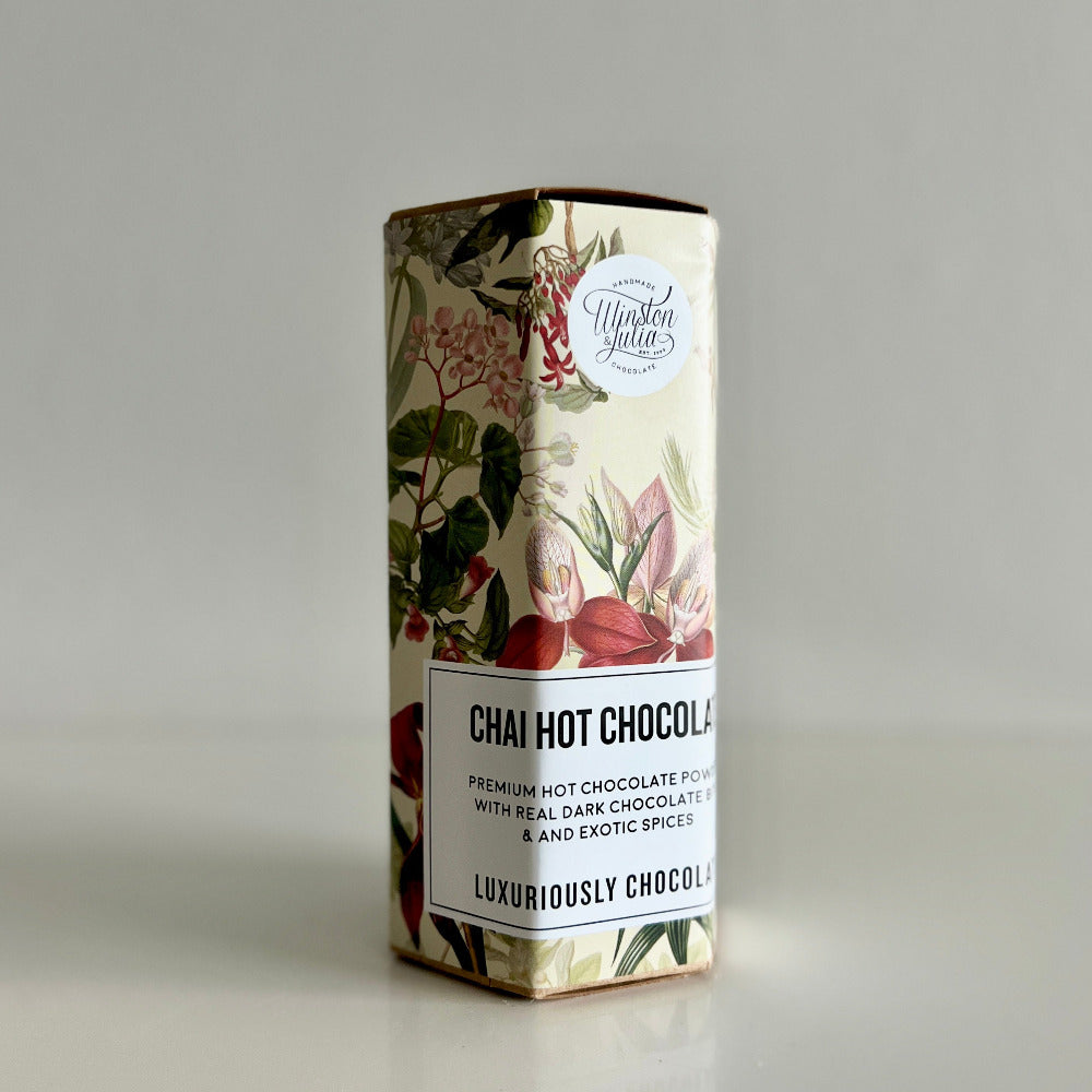 Box of Chai Hot Chocolate with floral design on a gray background