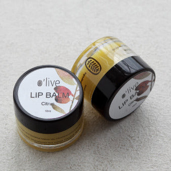 Two lip balm jars with 'olive' branding on a light gray background