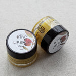 Load image into Gallery viewer, Two lip balm jars with &#39;olive&#39; branding on a light gray background
