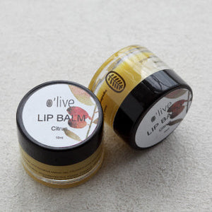 Two lip balm jars with 'olive' branding on a light gray background