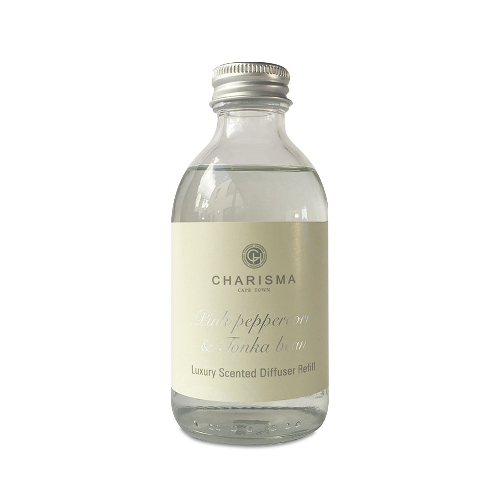 A glass bottle and a box packaging for a scented diffuser refill, with the label 'Pink Peppercorn & Tonka Bean' and 'Luxurious Scented Diffuser Refill'.