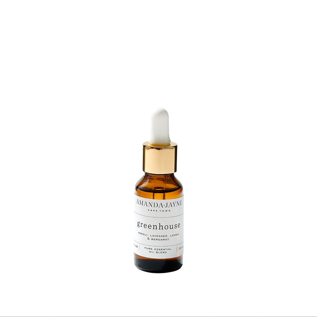 Amber glass dropper bottle with gold cap on a white background