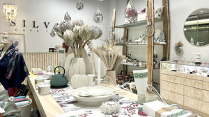 Decorative items on a table with 'SILVAN' branding in the background