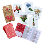 Load image into Gallery viewer, Flatlay of cards with flower illustrations as well as packaging of memory game with pink card backing. 
