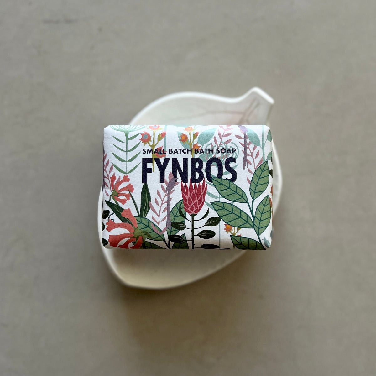 Bar of soap with 'FYNBOS' branding on a beige background