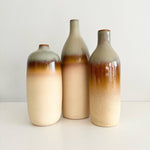 Load image into Gallery viewer, Three ceramic bottles with gradient coloring on a white background
