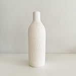Load image into Gallery viewer, White textured bottle-shaped vase on a light gray background
