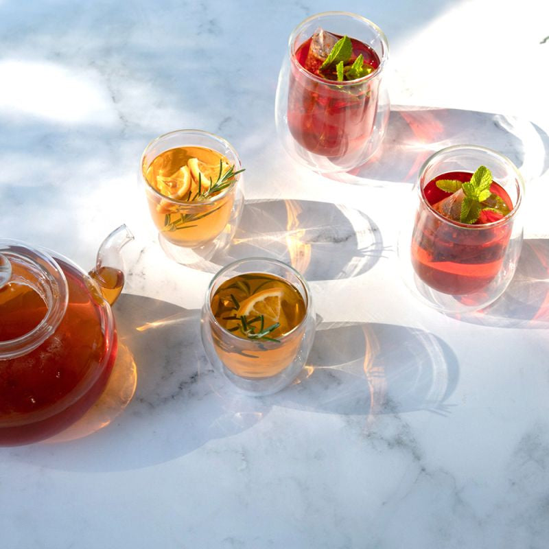 Tea glasses with lemon and mint on a marble surface