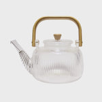 Load image into Gallery viewer, A clear glass teapot with a bamboo handle and a removable strainer
